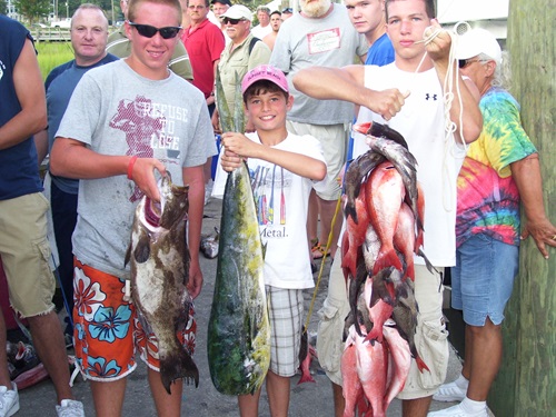 a group of people standing in front of a fish