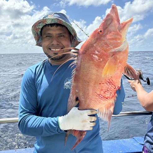 a person holding a fish in the water